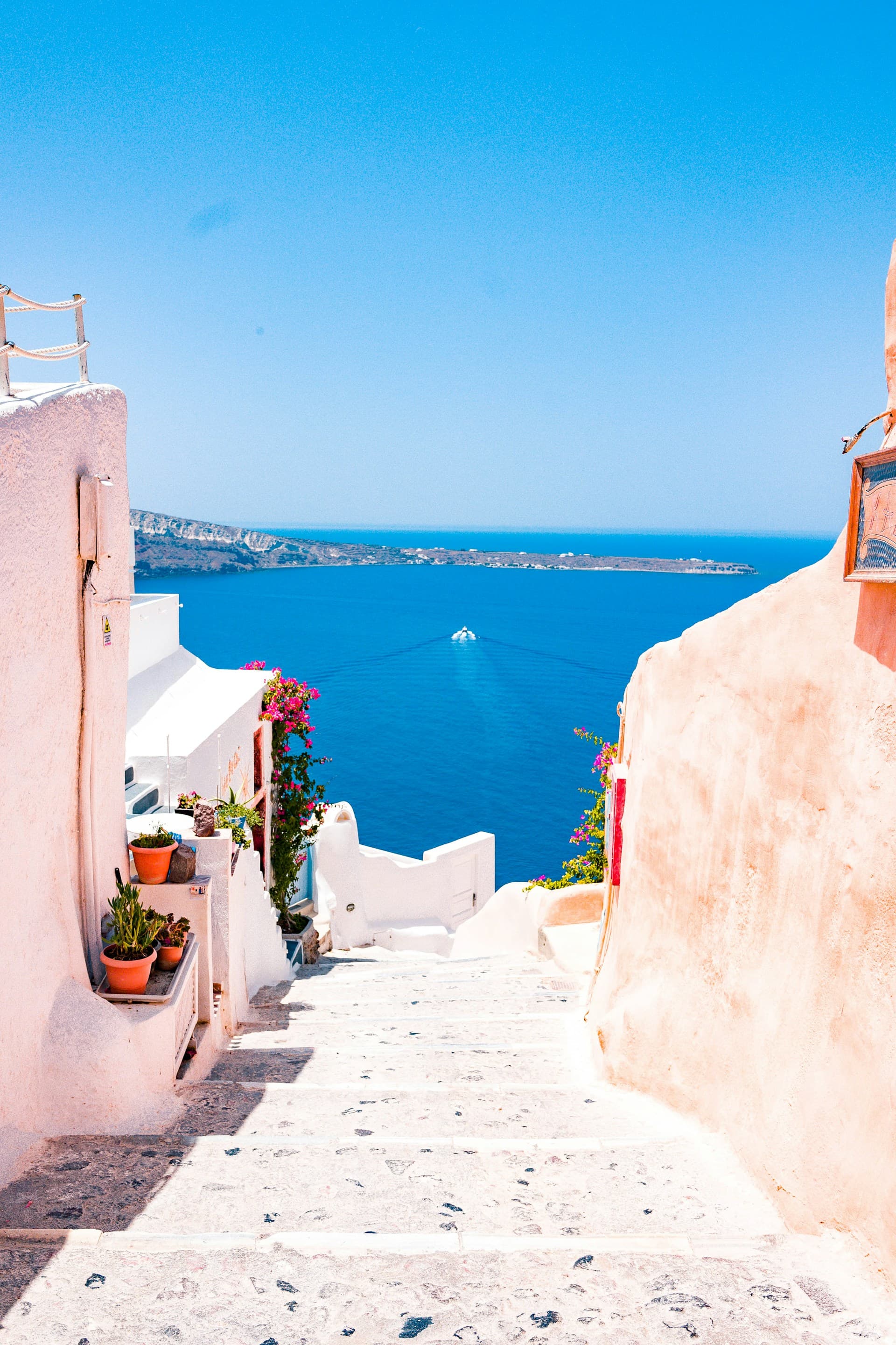 White-washed buildings with blue domes overlooking the Aegean Sea