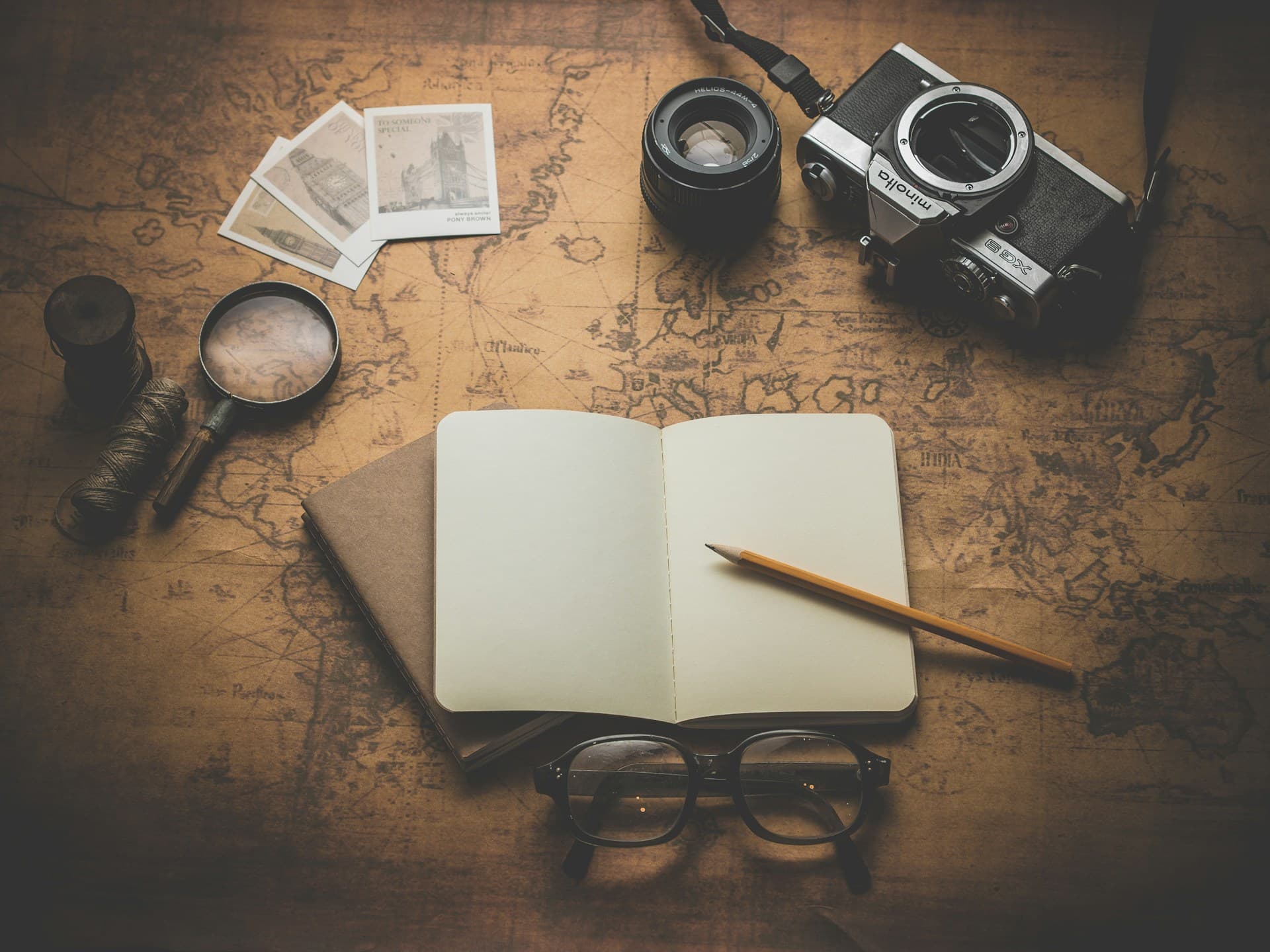World map with passport, camera, and travel accessories