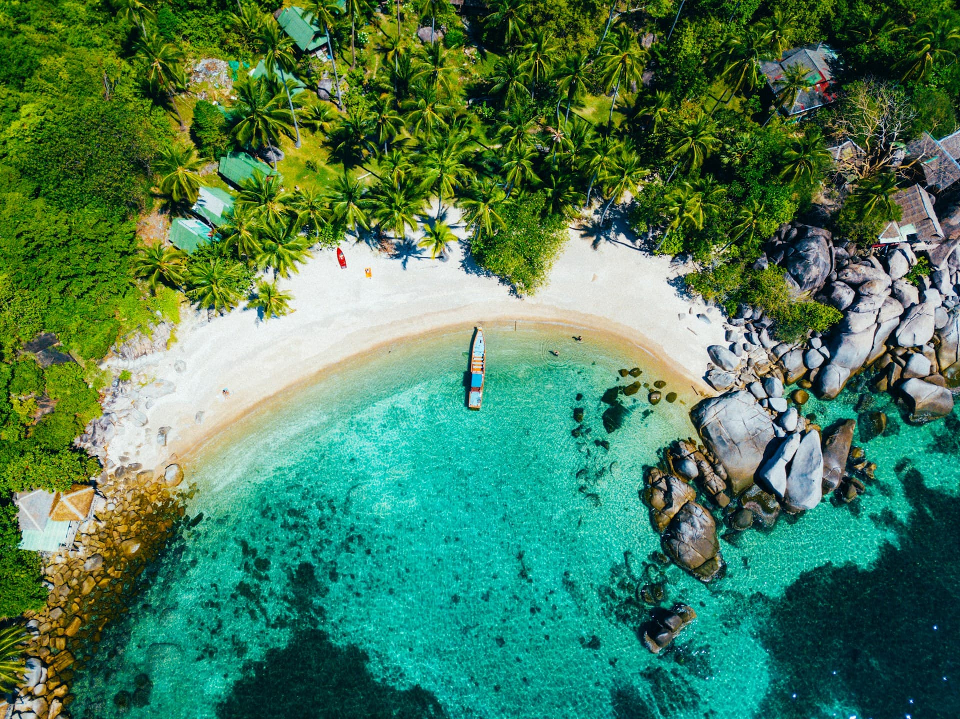 Crystal clear water with a traditional boat near a tropical island