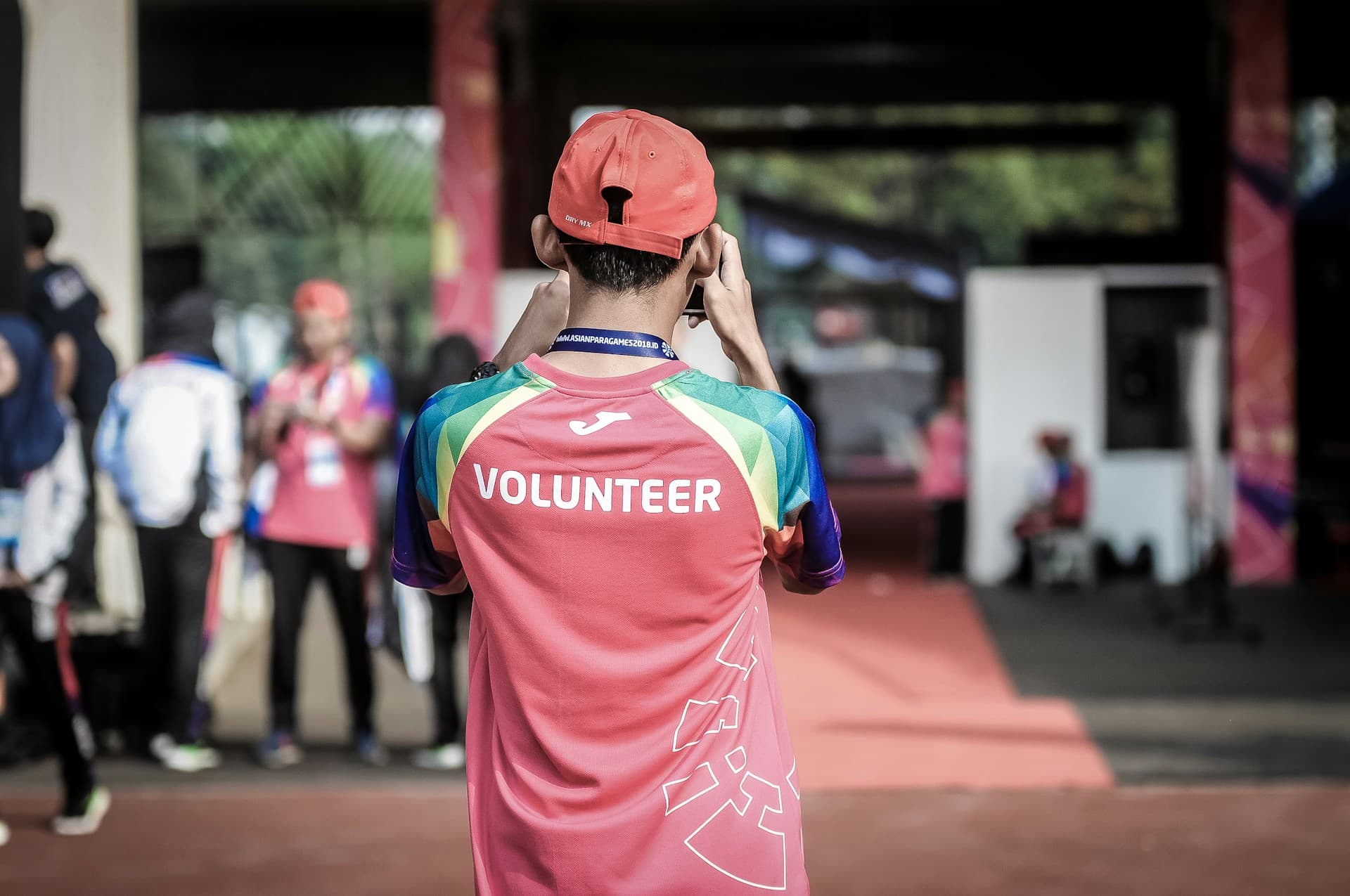Group of volunteers painting a community building in a tropical setting